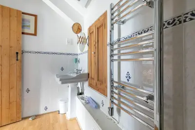 a bathroom with a sink and a mirror at Kota Restaurant & Rooms in Porthleven