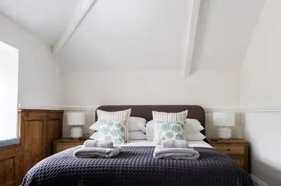 a bedroom with a bed with two pillows on it at Kota Restaurant & Rooms in Porthleven