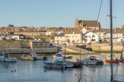 a group of boats are docked in a harbor at Kota Restaurant & Rooms in Porthleven