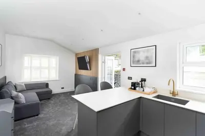 a kitchen and living room with a couch at Stunning new fully renovated flat in Marazion in Marazion