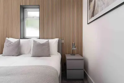 a bedroom with a white bed and a window at Stunning new fully renovated flat in Marazion in Marazion
