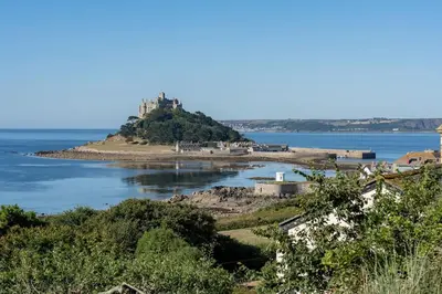 an island in the water with a castle on it at Stunning new 1 bed apartment in Marazion. in Marazion