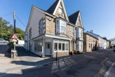 a building on the side of a street at Stunning new 1 bed apartment in Marazion. in Marazion