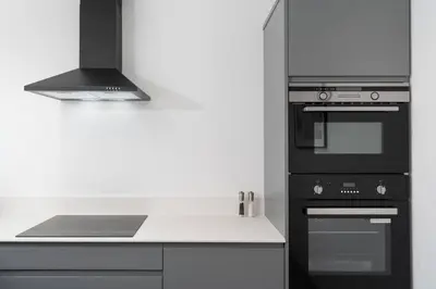 a kitchen with a stove and a stove top oven at Stunning new 1 bed apartment in Marazion. in Marazion