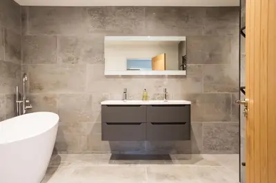 a bathroom with a sink and a mirror at Breakers View in Wadebridge