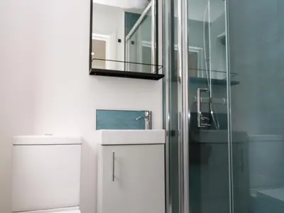 a bathroom with a shower and a mirror at Tredarn in Hayle