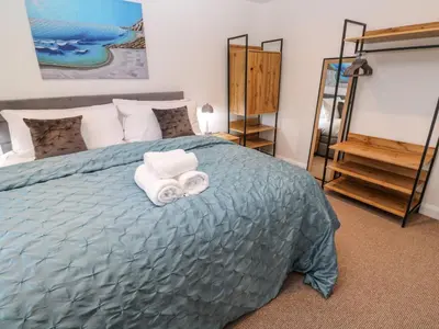 a bedroom with a bed with two towels on it at Tredarn in Hayle