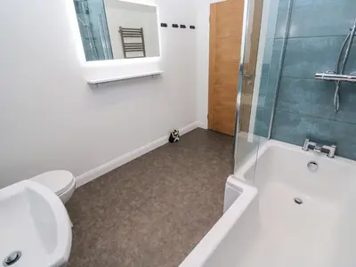 a bathroom with a toilet and a sink and a shower at Tredarn in Hayle