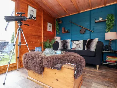 a camera in a room with a couch and a table at Inny Brook Cottage in Camelford