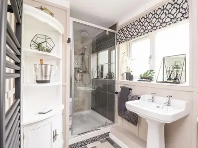 a bathroom with a sink and a shower at Inny Brook Cottage in Camelford