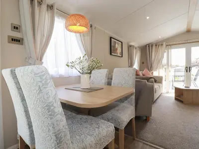 a dining room with a wooden table and chairs at Pams Place in Newquay