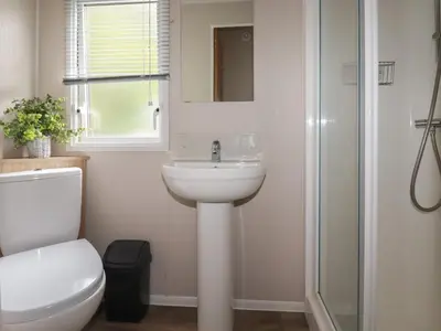 a bathroom with a sink and a toilet and a shower at Pams Place in Newquay