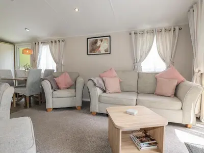 a living room with two couches and a table at Pams Place in Newquay