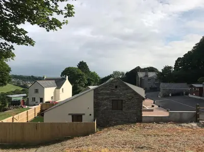 a view from the hill of a village with a building at Hendra Retreat Owls Roost Cottage North Cornwall in Camelford