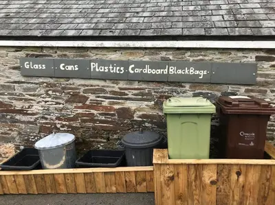 a wooden box with three trash cans and a sign at Hendra Retreat Owls Roost Cottage North Cornwall in Camelford