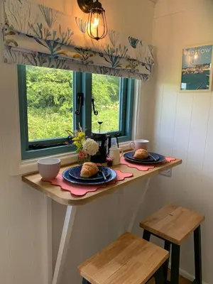 a kitchen with two plates of food on a counter at St. Kew Shepherd Huts in Wadebridge