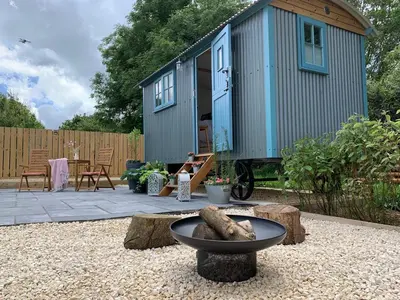 a tiny house sitting on top of a gravel yard at St. Kew Shepherd Huts in Wadebridge