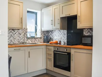 a kitchen with white cabinets and a sink at Pentarow in Constantine