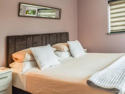 a bedroom with two beds and a mirror on the wall at Pentarow in Constantine