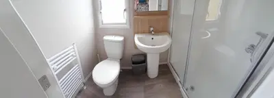 a small bathroom with a toilet and a sink at Lake view in Newquay