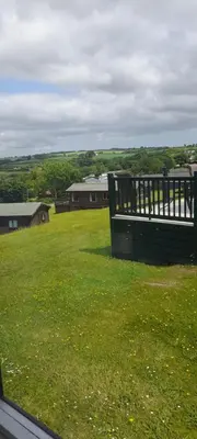 a view of a field of green grass with houses at Lake view in Newquay