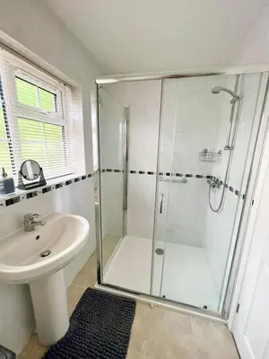 a bathroom with a shower and a sink at 14 Granite Henge in Looe