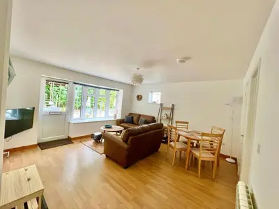 a living room with a couch and a table at 14 Granite Henge in Looe