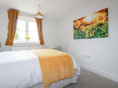 a bedroom with a bed and a painting on the wall at Chynoweth House in Newquay