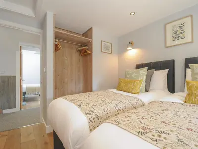 two beds sitting next to each other in a bedroom at Stargazy Cottage in Penzance