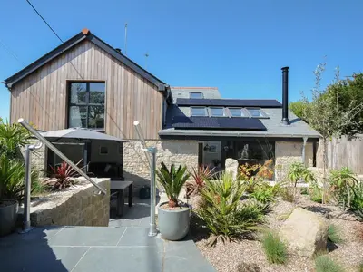 a house with solar panels on top of it at Stargazy Cottage in Penzance