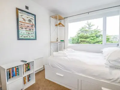 a bedroom with a white bed and a window at Pasadena in Newquay