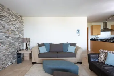 a living room with a couch and a table at 4 The Vista, Wi-Fi, Pet Friendly in Newquay