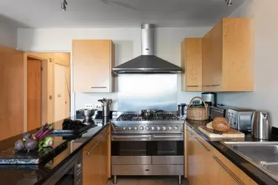 a kitchen with a stainless steel stove top oven at 4 The Vista, Wi-Fi, Pet Friendly in Newquay