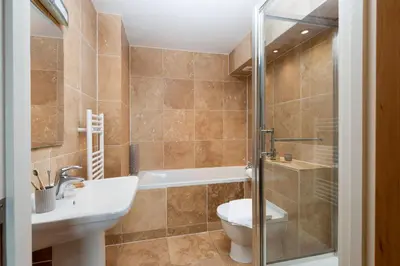 a bathroom with a toilet and a sink and a shower at 4 The Vista, Wi-Fi, Pet Friendly in Newquay