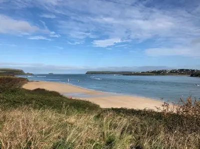 a sandy beach with the ocean in the background at Hawkers Padstow in Padstow