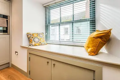 a window with two pillows sitting on a counter at Hawkers Padstow in Padstow