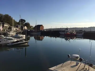 a group of boats are docked in a harbor at Hawkers Padstow in Padstow