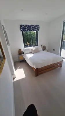 a bedroom with a large bed and a window at Luxury home near Fistral Beach in Newquay