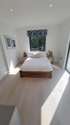 a bedroom with a large bed and a window at Luxury home near Fistral Beach in Newquay