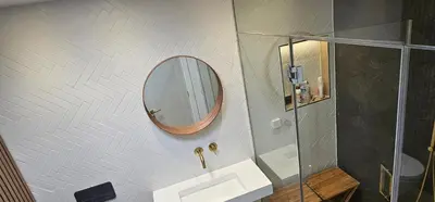 a bathroom with a sink and a mirror on the wall at Luxury home near Fistral Beach in Newquay