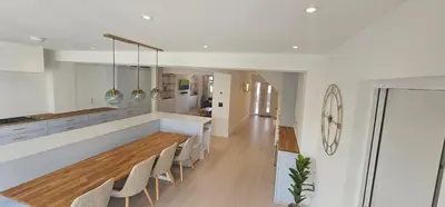 a kitchen with a long dining table and chairs at Luxury home near Fistral Beach in Newquay