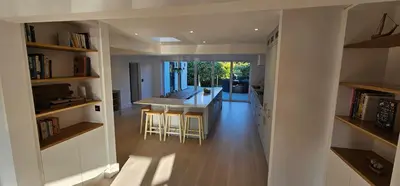 a kitchen and living room with a island in a house at Luxury home near Fistral Beach in Newquay