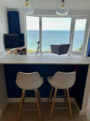 two chairs at a bar with a view of the ocean at Shoreline - one of the best views? in Carbis Bay