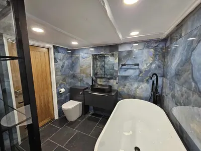 a bathroom with a tub and a toilet and a sink at Shell Cottage, St Ives in St Ives