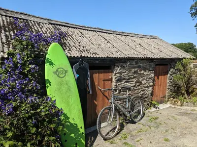 a surfboard and a bike parked next to a building at Foxglove Cottage in Launceston