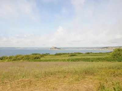 a field with a view of the ocean at Wheal Charlotte Cottage in Penzance