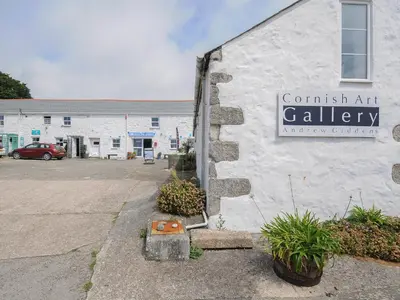 a building with a sign on the side of it at Wheal Charlotte Cottage in Penzance