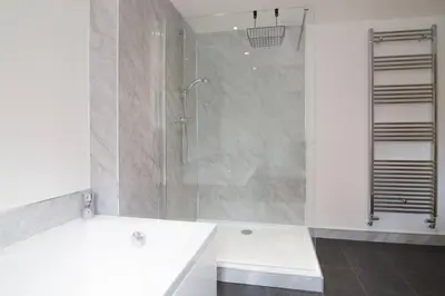 a bathroom with a shower and a white tub at Hendra Retreat Piglets Cottage North Cornwall in Camelford