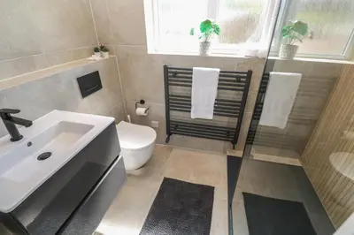 a bathroom with a sink and a toilet and a window at Island View in Newquay