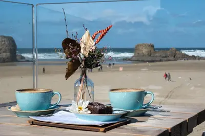 two cups of coffee on a table at the beach at Wheal Kitty nr Truro in Truro